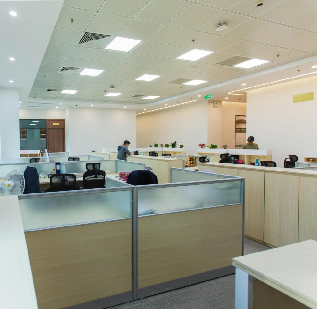 Spacious modern open office with workstations and natural lighting, optimal for productivity.